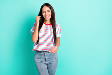 Photo of charming attractive lovely young woman look empty space hold hand pocket isolated on teal color background