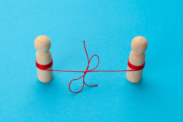 Family affection. The concept of a date for a couple in love. Two figures of people connected by a thread.