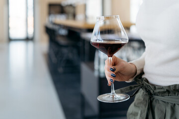 Glass of red wine in a female hand