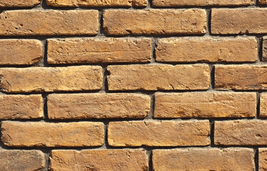 Texture of brick wall. Samples of wall or fence are presented at exhibitions. Orange brick close up.