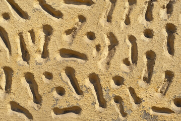 Plaster on a yellow wall. Concrete wall texture close up.
