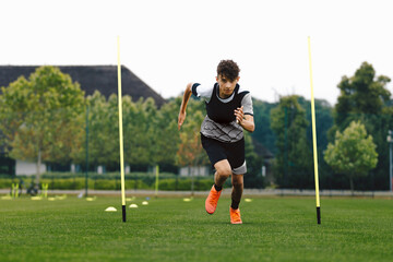 Teenage Athlete on Running Training Speed Tests. Young Boy Running Fast in Cleats and Soccer Sports...