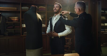Cinematic shot of professional tailor taking measurements of client for creation custom tailored...