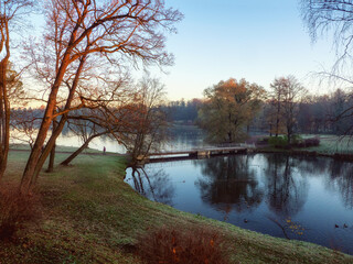 Morning autumn landscape with a lake and the first rays of the sun. Palace Park. Gatchina.