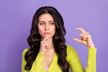 Photo portrait of sad unhappy brunette showing fingers little amount size isolated on pastel violet...