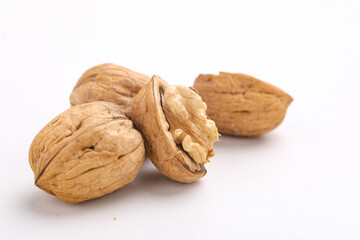 Walnuts and cracked walnut, isolated on white background