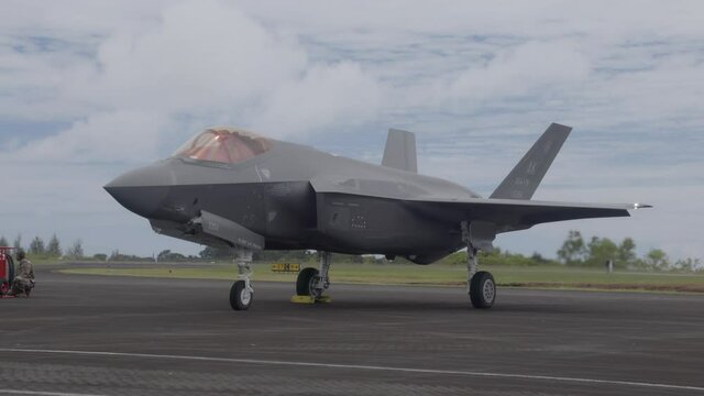 F-35 Stealth Jet Fighter sits on tarmac with engines running