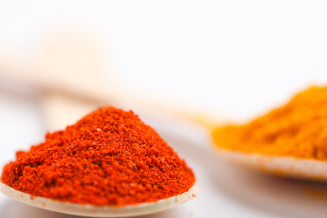 red chili powder in spoon on white background.