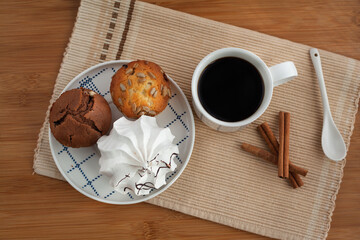 Serving tray with sweet dessert and cup of coffee in bed, white sheets, and blanket in the hotel. Romantic start of the day, coffee in bed with organic dessert.