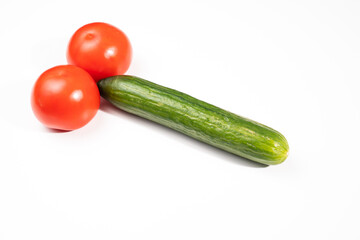 tomatoes and cucumber in the form of a male sexual organ on a white background. medications and diet for male potency. infertility problem. erotic picture. humor