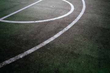 white lines on green basketball court