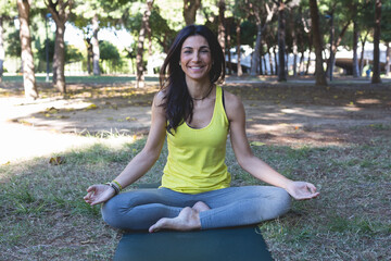 Smiling woman on a yoga practice at park
