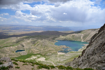 Small Arashan and Upper Arashan lakes and the view of the latitudes of the Chatkal Valley. View about at an altitude of 3300 meters above sea level. Namangan region, Uzbekistan