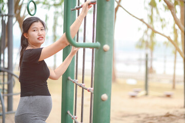 Fototapeta premium Pregnant women exercise on the playground