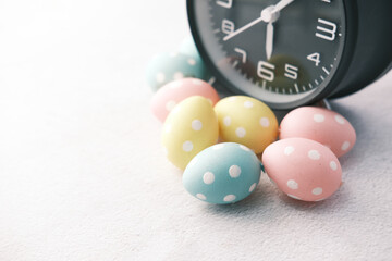 easter concept with egg and alarm clock on white background.