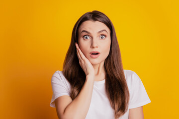 Photo of lady hand cheek excited face wear white t-shirt posing on yellow background