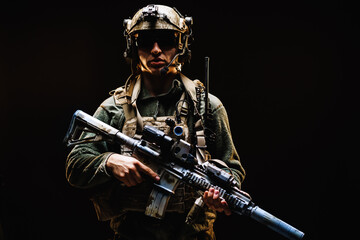 Fototapeta na wymiar Special forces soldier with rifle on black background