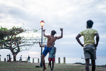 Young men exercising martial arts on the beach