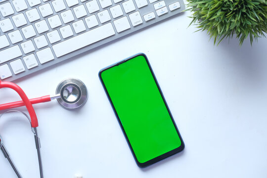 High Angle View Of Pills, Smart Phone And Stethoscope On Clinic Desk,