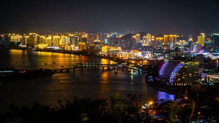 Fototapeta na wymiar Sanya city nightscape with illuminated buildings in Sanya Hainan China