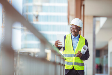 Portrait of african american man architect at building site. Confident construction manager in formal clothing wearing white hardhat. Successful mature civil engineer at construction site 