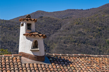 Picturesque chimney on the roof of an old house in swiss village Morcote at lake Lugano