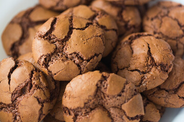 Homemade chocolate cookies brookies on white paper napkin and dark chocolate slices