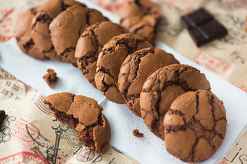 Homemade chocolate cookies brookies on white paper napkin and dark chocolate slices