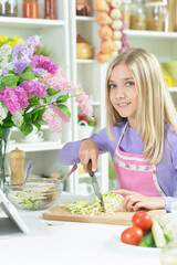 Cute girl preparing fresh salad