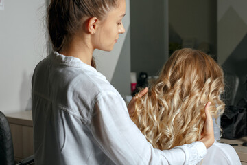 Hair stylist holding client's hair