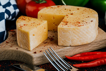 Cheese dish with organic cheeses, fruits, nuts on a wooden background. Delicious cheese snack