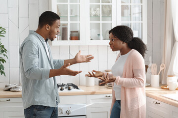 Fototapeta premium Crisis In Relationship. Portrait Of Black Man And Woman Arguing In Kitchen