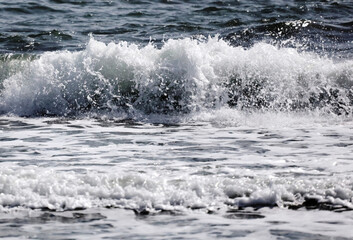 Beautiful waves crashing on the shore, with white foam