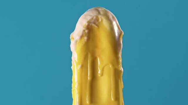 Time laps. Bright Yellow ice cream melts quickly on a blue background