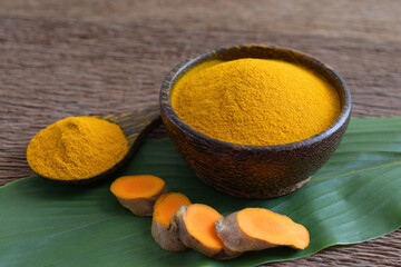 Turmeric powder and fresh turmeric (curcumin) on wooden background,Used for cooking,Herbal,copy space.