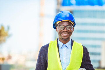 Portrait of smiling Engineer - Architect looking at camera. Working on a new office building. Happy mid adult engineer. Cheerful Engineer ready for Action !