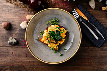 Breakfast omelette with champignon on wooden background