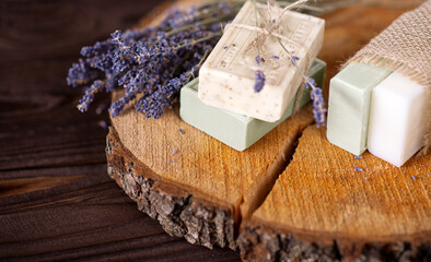Obraz na płótnie Canvas Soap SPA banner. Aromatic Natural Soap with lavender flowers on wooden background, top view