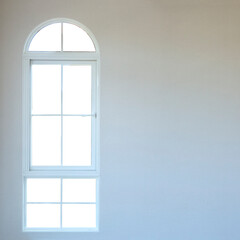 Two half-moon windows white frame at the white room with white backgrounds. Interior empty room wall and windows in a luxury house.