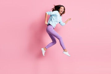 Fototapeta na wymiar Full size profile side photo of young excited woman happy run hurry jump sale wear purple pants isolated over pastel color background