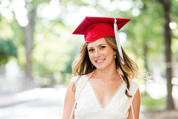 portrait of a young female graduate in the park