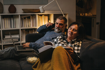 middle age couple spending time together at home. evening scene