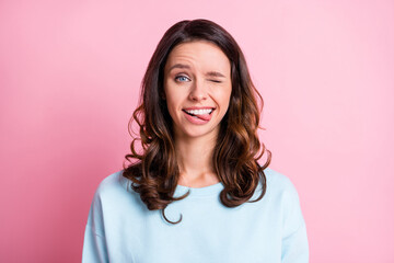 Photo of young beautiful girl happy smile make faces blink eye bite tongue isolated over pastel...