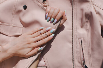 Beautiful youth manicure. The design is a mix of pink and blue. Unicorn color varnish. Gel polish...