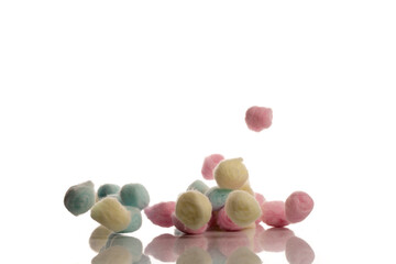Colorful cotton make up balls, falling, isolated on white background.