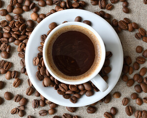 Coffee cup and a scattering of coffee beans