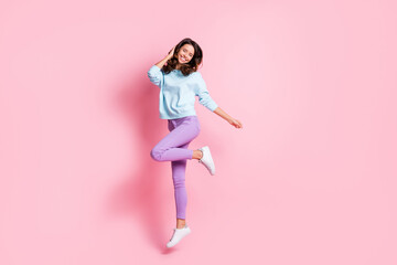 Fototapeta na wymiar Full length body size view of attractive dreamy cheerful fit wavy-haired girl jumping enjoying good mood isolated over pink pastel color background