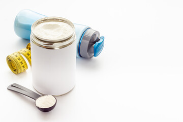 Whey protein in scoop and jar with tape measure. Sport nutrition