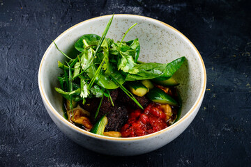 Falafel and fresh vegetables salad on dark background. Vegetarian, diet food concept.