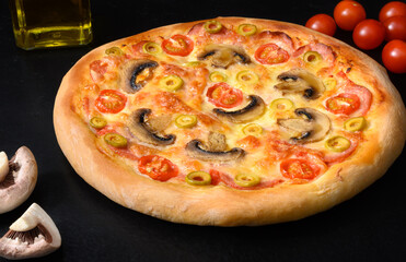 Pizza with tomatoes, mozzarella, salami, mushrooms, oil on black background